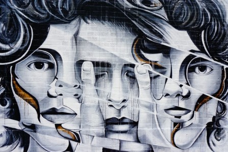 Three woman heads painted on a wall