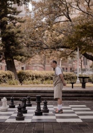 Man standing on a big chess board